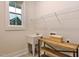 Functional laundry room with a large window, utility sink, wooden shelving, and ample storage at 285 Gilliland Rd, Siler City, NC 27344
