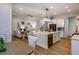 Open living space with kitchen island, living room fireplace and hardwood floors at 285 Gilliland Rd, Siler City, NC 27344