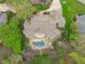 Aerial view of a stunning home featuring a private pool, patio, and landscaped yard, set within a wooded neighborhood at 2922 Bells Pointe Ct, Apex, NC 27539