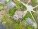 Aerial view showcasing a luxurious home with a pool, patio, and lush landscaping in a serene neighborhood at 2922 Bells Pointe Ct, Apex, NC 27539