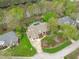 Large home with lush landscaping, in ground pool, and a riverside setting captured from an aerial perspective at 2922 Bells Pointe Ct, Apex, NC 27539