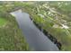 Expansive aerial view showcasing a lakefront property with surrounding woods and neighborhood in a serene, natural setting at 2922 Bells Pointe Ct, Apex, NC 27539