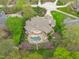 Aerial perspective of a beautiful backyard with a pool, spa, outdoor seating, and meticulous landscaping around the property at 2922 Bells Pointe Ct, Apex, NC 27539