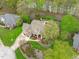 Aerial view of a large home with a pool, beautifully landscaped yard, and proximity to a scenic river at 2922 Bells Pointe Ct, Apex, NC 27539