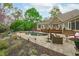Expansive backyard featuring a custom pool, outdoor seating, stone patio, and lush landscaping for entertaining at 2922 Bells Pointe Ct, Apex, NC 27539