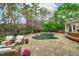Spacious backyard featuring an in-ground pool, patio seating, and lush landscaping at 2922 Bells Pointe Ct, Apex, NC 27539