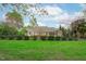 Spacious backyard with manicured lawn and view of exterior at 2922 Bells Pointe Ct, Apex, NC 27539