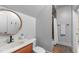 Cozy bathroom featuring a sink with wooden vanity, toilet, and shower with decorative brown tile at 2922 Bells Pointe Ct, Apex, NC 27539