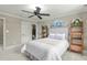 Bedroom featuring a bed, decor, and two doorways one leading to an ensuite bathroom at 2922 Bells Pointe Ct, Apex, NC 27539