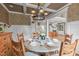 Elegant dining room features a coffered ceiling, chandelier, and round table set for a dinner party at 2922 Bells Pointe Ct, Apex, NC 27539