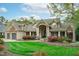 Charming home with a manicured front yard, lush landscaping, and an inviting entrance with prominent architectural details at 2922 Bells Pointe Ct, Apex, NC 27539
