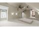 Spacious home theater with projector, ceiling fan, raised seating platform, and adjoining room at 2922 Bells Pointe Ct, Apex, NC 27539