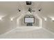 Unfurnished home theater with white walls, a large screen, ceiling fan, and recessed lighting at 2922 Bells Pointe Ct, Apex, NC 27539