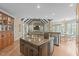 Open kitchen featuring a large island, stainless steel appliances, and hardwood floors at 2922 Bells Pointe Ct, Apex, NC 27539