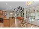 Open kitchen concept with dark wood beams, an island with seating, and a view to an adjacent living space at 2922 Bells Pointe Ct, Apex, NC 27539