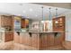 Large kitchen with wood cabinets, granite countertops, stainless steel appliances, and hardwood floors at 2922 Bells Pointe Ct, Apex, NC 27539