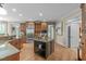 Kitchen featuring a center island with granite countertops, wood cabinets, and stainless steel appliances at 2922 Bells Pointe Ct, Apex, NC 27539