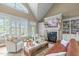 Comfortable living room with large windows, vaulted ceilings, fireplace and built-in shelving at 2922 Bells Pointe Ct, Apex, NC 27539