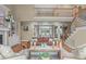 Spacious living room featuring staircase, large windows, fireplace, built-in shelves, and comfortable seating at 2922 Bells Pointe Ct, Apex, NC 27539