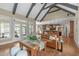 Open concept living room with exposed beam vaulted ceilings, stone fireplace, and hardwood floors at 2922 Bells Pointe Ct, Apex, NC 27539