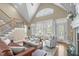 Inviting living room features vaulted ceilings, large windows, a staircase, and comfortable seating at 2922 Bells Pointe Ct, Apex, NC 27539