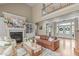 Elegant living room with fireplace, built-in shelving, and staircase offers comfortable and stylish living space at 2922 Bells Pointe Ct, Apex, NC 27539