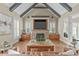 Living room with a stone fireplace, vaulted ceilings, built-in cabinets, and lots of natural light at 2922 Bells Pointe Ct, Apex, NC 27539