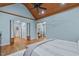Spacious main bedroom featuring wood ceiling, hardwood floors, blue walls, and views to a home gym at 2922 Bells Pointe Ct, Apex, NC 27539