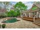 Custom pool and hot tub with stone patio near a wood deck at 2922 Bells Pointe Ct, Apex, NC 27539