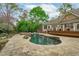 Landscaped in-ground pool and spa with stone patio and outdoor space for entertaining at 2922 Bells Pointe Ct, Apex, NC 27539