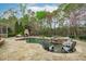 Lush backyard featuring a beautiful pool, spa, comfortable lounge chairs, and a stone fireplace for outdoor relaxation at 2922 Bells Pointe Ct, Apex, NC 27539