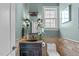 Elegant powder room with decorative mirror, sconces, and detailed tile work at 2922 Bells Pointe Ct, Apex, NC 27539