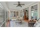 Bright sunroom with ceiling fan, large windows, and view to the interior of this charming home at 2922 Bells Pointe Ct, Apex, NC 27539