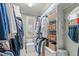 Walk-in closet featuring ample storage with built-in shelves, hanging rods, and a dressing area at 2922 Bells Pointe Ct, Apex, NC 27539