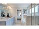 This bathroom has double sinks, a bathtub, a large mirror, and a glass enclosed shower at 300 Seagraves Creek Ln, Holly Springs, NC 27540