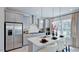 Modern kitchen featuring stainless steel appliances, an island with seating, and ample cabinet space at 300 Seagraves Creek Ln, Holly Springs, NC 27540
