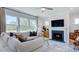 Cozy living room with fireplace, large windows, and comfortable seating at 300 Seagraves Creek Ln, Holly Springs, NC 27540