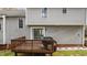 View of a home's back deck featuring a grill and overlooking a nicely landscaped yard at 301 Tillamook Dr, Wake Forest, NC 27587