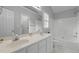 White bathroom with double sink vanity, large mirror, and shower-tub combo, offering both style and functionality at 301 Tillamook Dr, Wake Forest, NC 27587