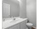 Neat half-bath with white vanity and mirror, perfect for guests' convenience at 301 Tillamook Dr, Wake Forest, NC 27587