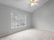 Bright bedroom with a vaulted ceiling, a neutral color scheme, and a large window at 301 Tillamook Dr, Wake Forest, NC 27587