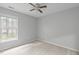 Serene bedroom featuring a ceiling fan and a window offering plenty of natural light and neutral decor at 301 Tillamook Dr, Wake Forest, NC 27587