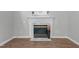 Close-up of marble fireplace with white mantel and decorative accents in the living room at 301 Tillamook Dr, Wake Forest, NC 27587