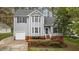 Charming two-story home with gray siding, a well-manicured lawn, and an inviting front entrance at 301 Tillamook Dr, Wake Forest, NC 27587