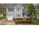 Charming two-story home with gray siding, a well-manicured lawn, and an inviting front entrance at 301 Tillamook Dr, Wake Forest, NC 27587