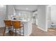 Bright white kitchen featuring a breakfast bar area and a sink under a bay window at 301 Tillamook Dr, Wake Forest, NC 27587