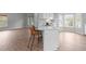 Bright white kitchen featuring a breakfast bar area and a sink under a bay window at 301 Tillamook Dr, Wake Forest, NC 27587