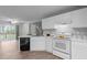 Cozy kitchen with white appliances and cabinets, complemented by wood-look flooring at 301 Tillamook Dr, Wake Forest, NC 27587