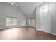 Bright living room featuring vaulted ceilings, hardwood floors, and natural light from large windows at 301 Tillamook Dr, Wake Forest, NC 27587