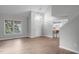 Bright living room featuring hardwood floors, ample natural light, and open layout into kitchen at 301 Tillamook Dr, Wake Forest, NC 27587